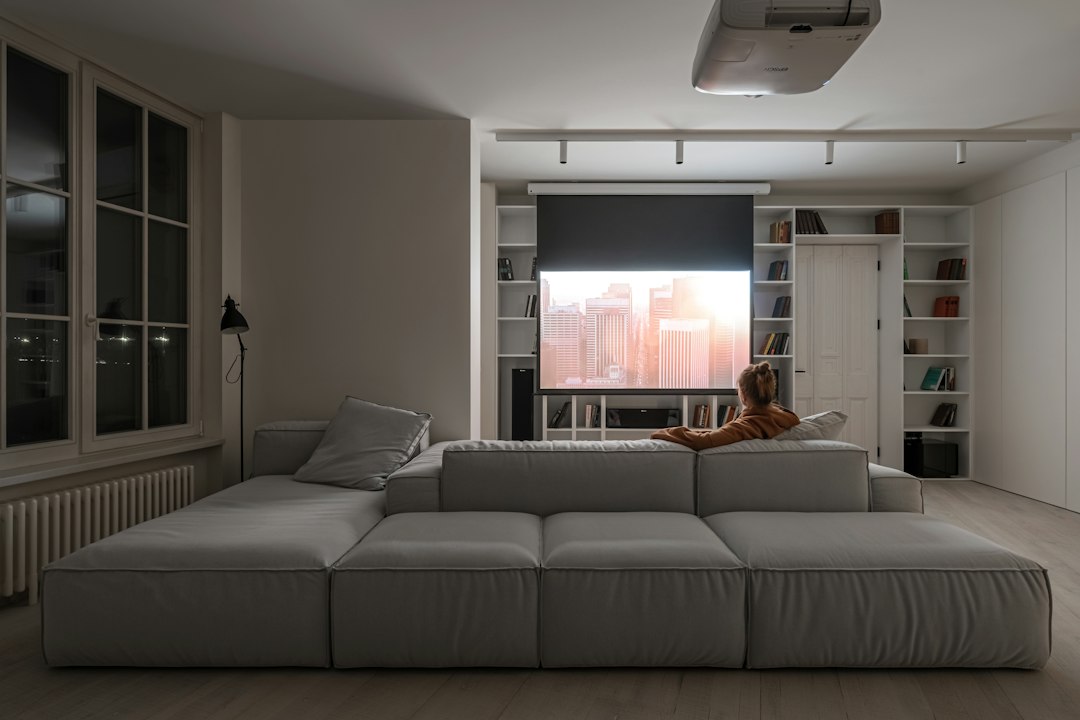 Cover illustration for movie night ideas showing popcorn, a projector beam, and a comfy couch