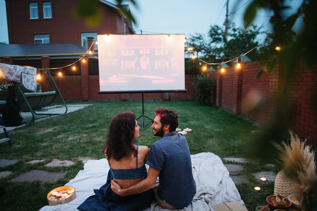 Cover illustration for movie night checklist with popcorn, projector, couch, and a clipboard of tasks